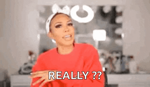 a woman wearing a red sweater and a headband is asking , `` really ? '' .