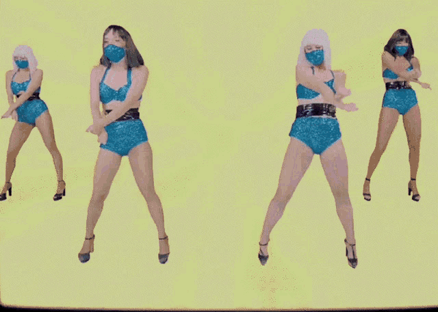 a group of women wearing masks are dancing