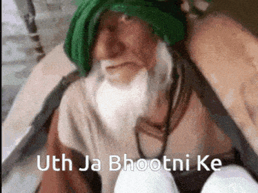 a man with a beard and a green turban says uth ja bhootni ke .