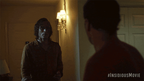 a movie poster for the insidious movie shows a man looking at himself in the mirror