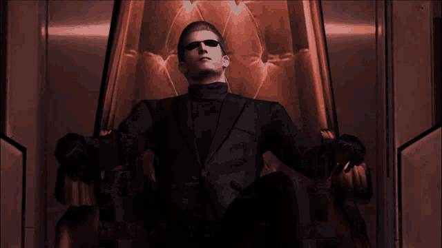 a man in a suit and sunglasses sits on a throne