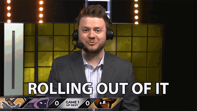 a man in a suit and headphones says " rolling out of it "
