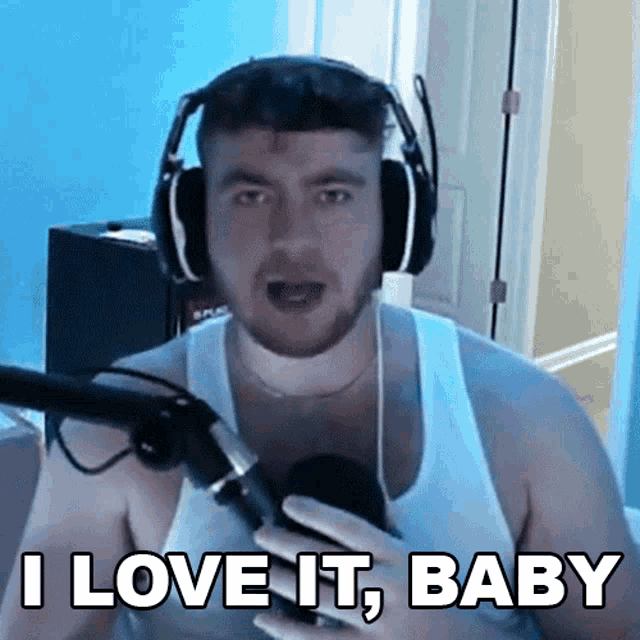 a man wearing headphones is holding a microphone and says i love it baby