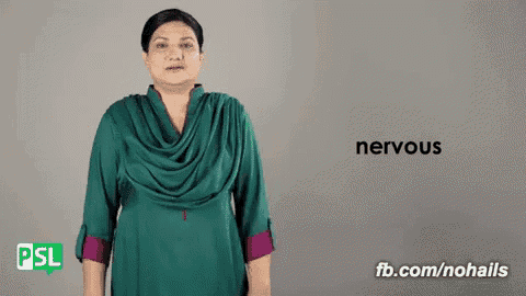 a woman in a green dress says nervous in sign language .