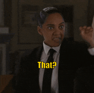 a woman in a suit and tie is saying that