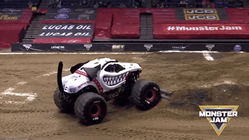 a monster jam truck is driving down a track