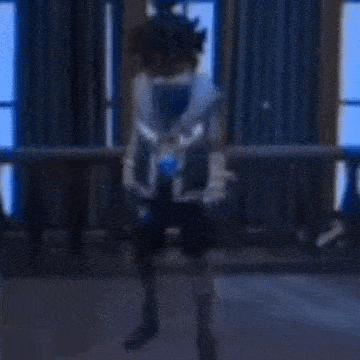 a blurry picture of a person dancing in a room with a balcony .