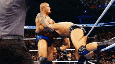 two wrestlers in a wrestling ring with the word ck on the ropes