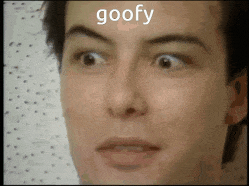 a close up of a man 's face with the word goofy written above it