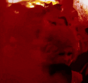 a woman in a red dress is smiling in a red room
