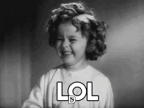 a black and white photo of a little girl laughing with the words lol written on her face .