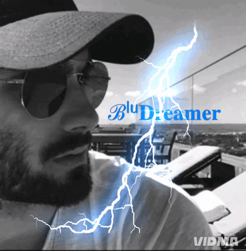 a man wearing sunglasses and a hat with lightning behind him and the words blu dreamer on the bottom