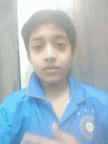 a young boy wearing a blue shirt is laying down