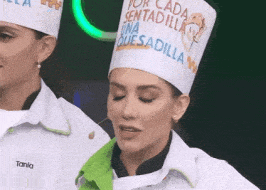 a woman wearing a chef 's hat that says tania on it