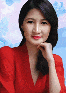 a woman in a red shirt with her hand on her face