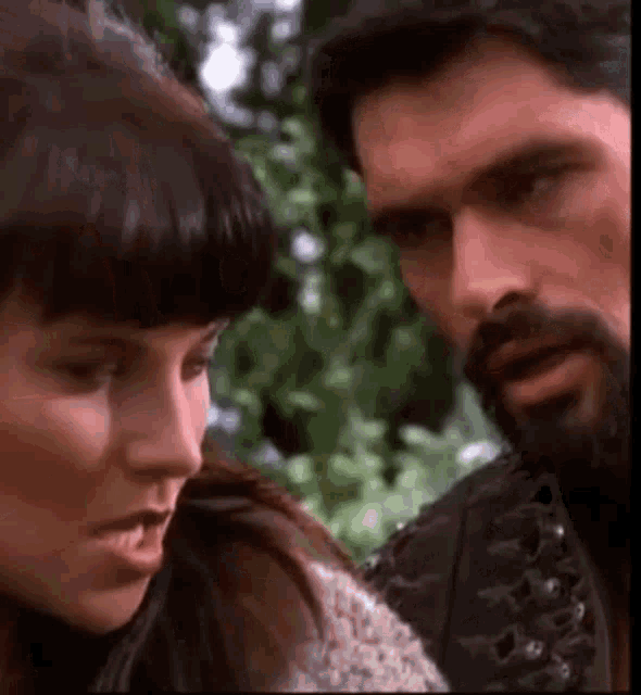 a man and a woman are looking at each other in a close up .