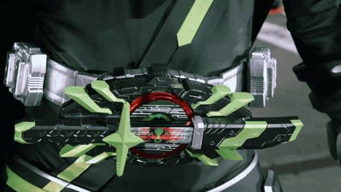 a person is wearing a belt with a green and red item on it