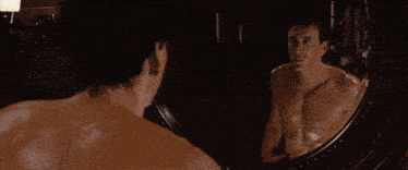 a man 's back is reflected in a round mirror