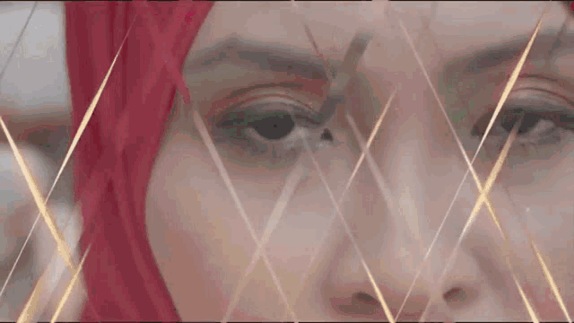 a close up of a woman 's face with a red hijab on