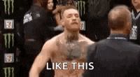 a man with a tattoo on his chest is standing in front of a referee and saying `` like this '' .