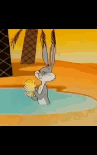 bugs bunny is standing in a pool holding a duck in his hand .