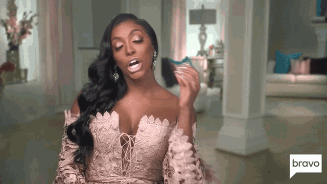 a woman in a white lace dress is on bravo tv