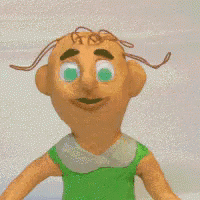 a stuffed doll with green eyes and brown hair