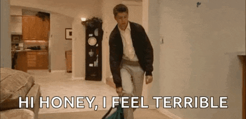 a man is walking through a living room with a suitcase .