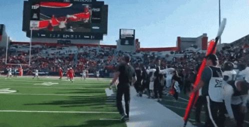 a football game is being played in a stadium with a scoreboard that says texas tech
