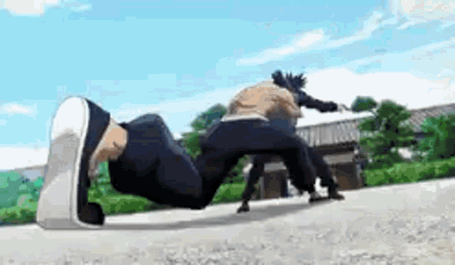 a man is doing a handstand on the ground while another man kicks him in the face .