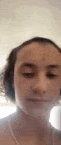 a close up of a person 's face with their eyes closed and their hair blowing in the wind .