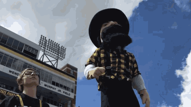 a mascot stands in front of murphy jr. field