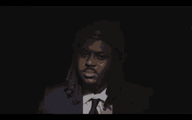 a man with dreadlocks wearing a beanie that says ' apollo ' on it