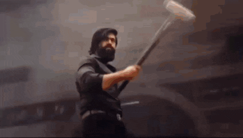 a man with a beard is holding a sword in front of the word subash