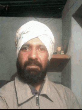 a man with a beard is wearing a turban