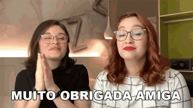 two women praying with the words muito obrigada amiga written above them