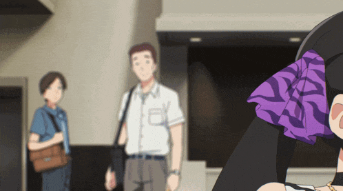 a man in a white shirt is standing in front of a woman in a purple shirt