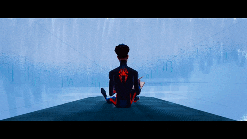 a man with a spider on his back sits on a ledge