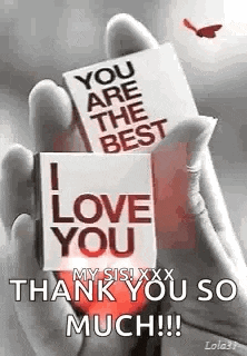 a person is holding a card that says `` you are the best i love you '' in their hand .