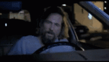 a man driving a car with the words you 're just an asshole written on the bottom