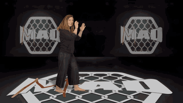 a woman stands on a mat with the word mad behind her