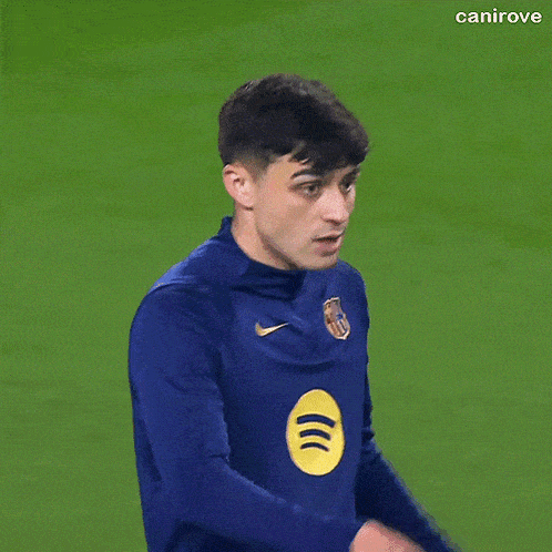 a soccer player is wearing a blue nike shirt
