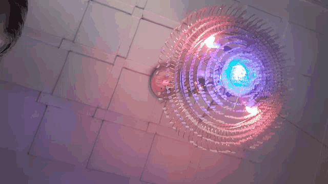 a chandelier with purple and blue lights on it