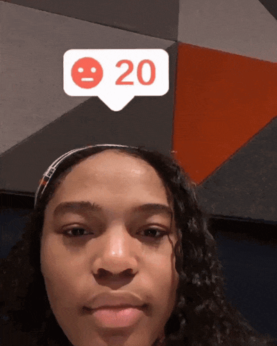 a woman 's face with a smiley face and the number 20 on it