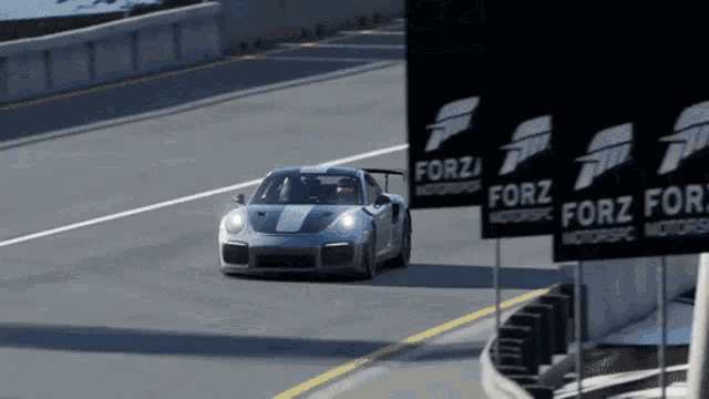 a car is driving down a road next to signs that say forz