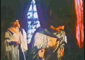 a group of people are standing in a dark room with a man laying on the ground