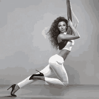 a woman is doing aerial acrobatics on a rope .