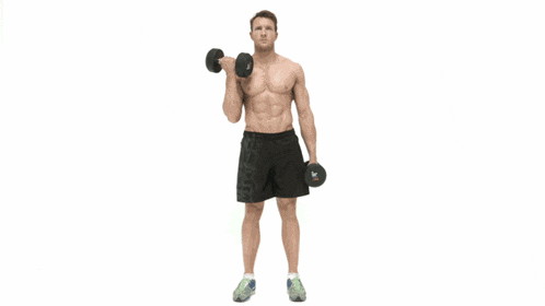 a shirtless man is holding dumbbells in his hands