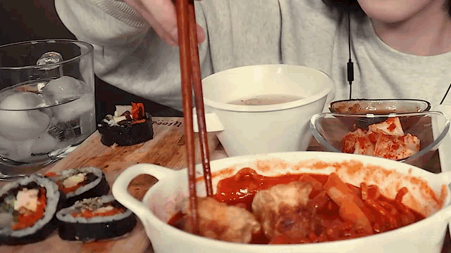a person is holding chopsticks over a bowl of food that says happy