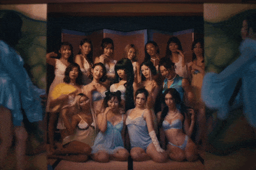 a group of women posing for a picture in front of a snake